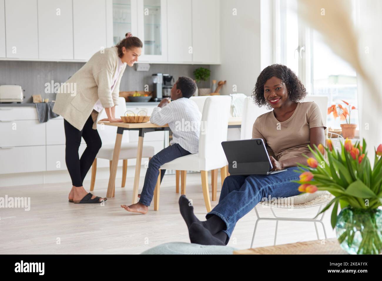 Family working and having meal at home Stock Photo