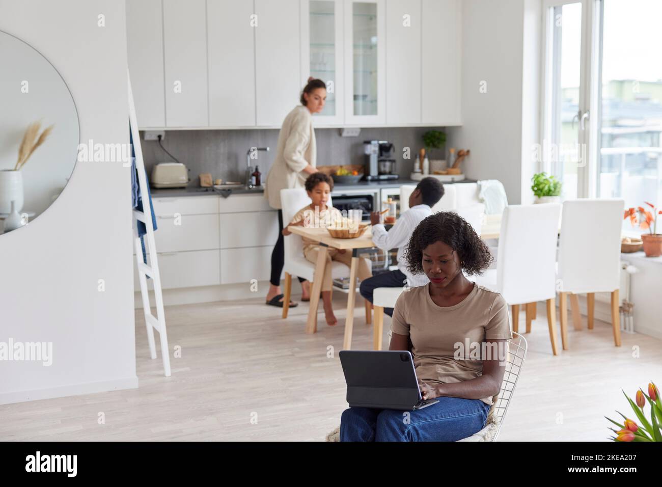 Family working and having meal at home Stock Photo