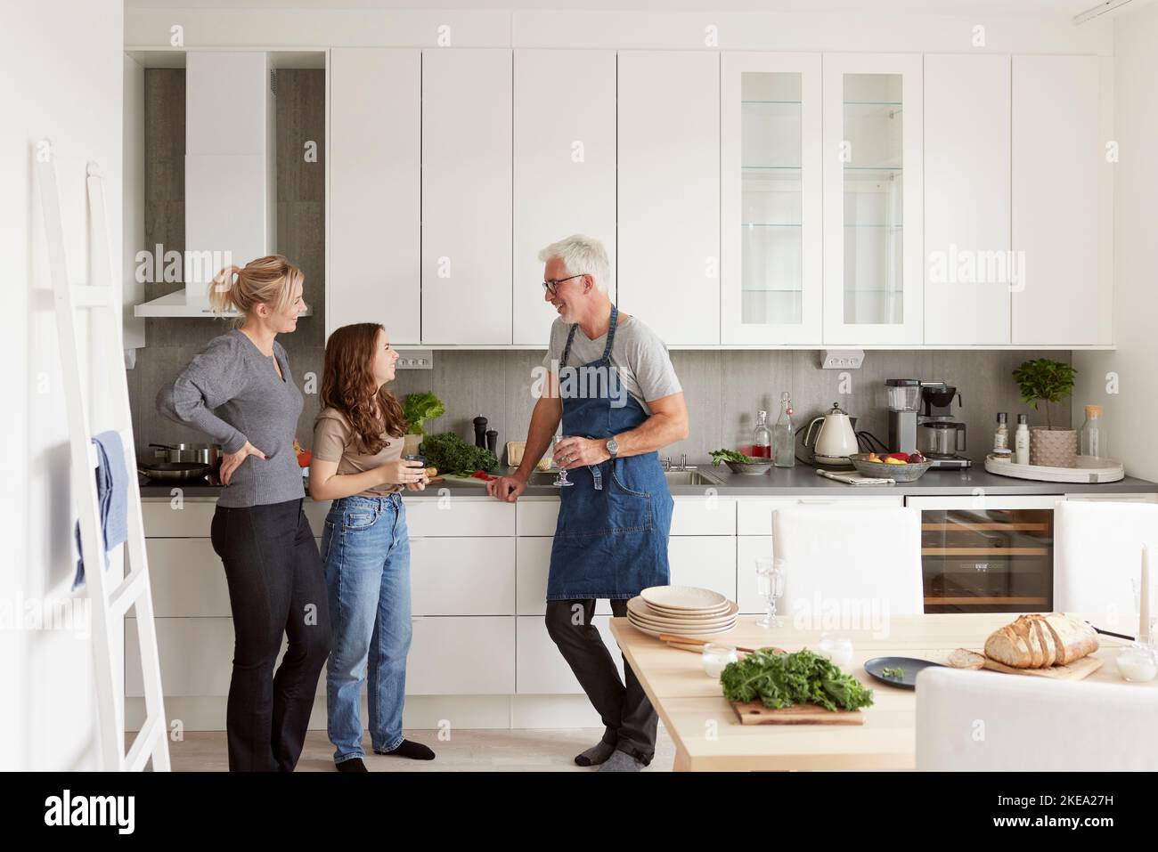 Family standing in kitchen Stock Photo