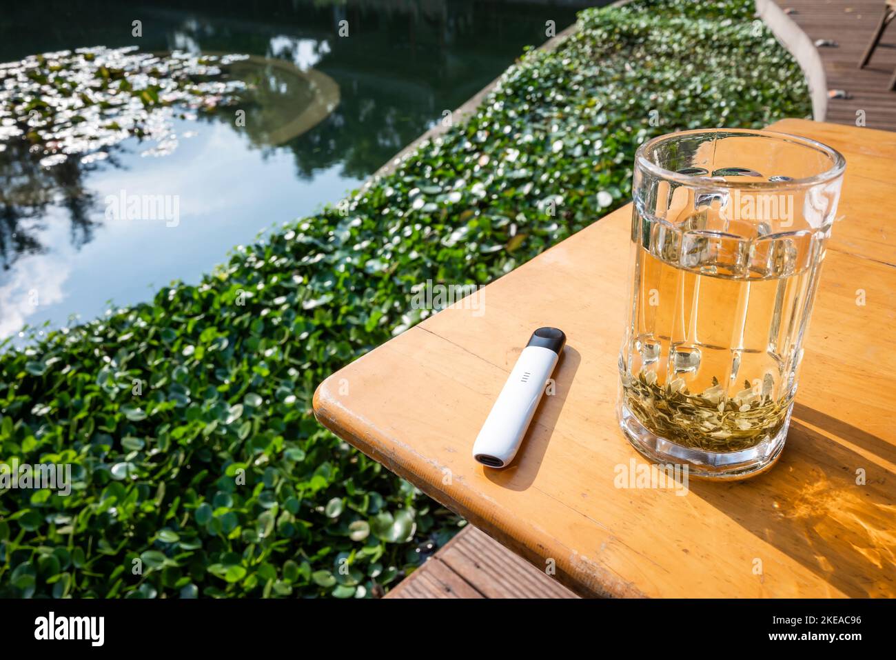 Electronic cigarette on a wooden table close-up view Stock Photo