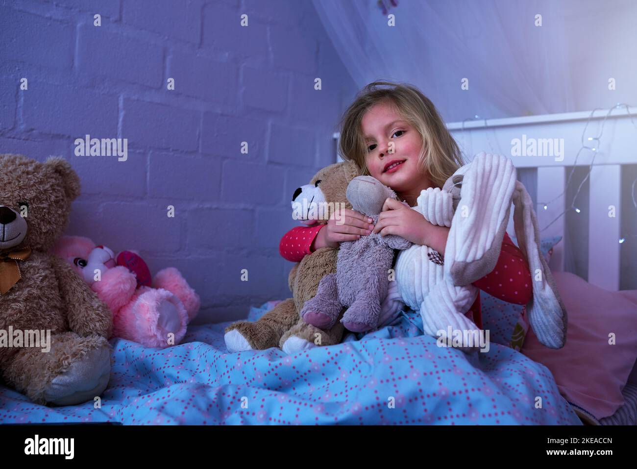 Time for bed my little friends. Portrait of a little girl hugging her