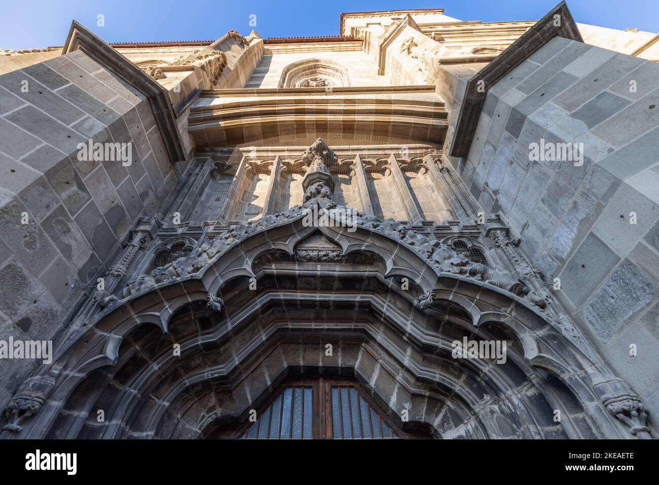Black Church (Biserica Neagra) western facade shows rich decor of ornamental and figurative sculpture of sandstone. Brasov, Romania Stock Photo