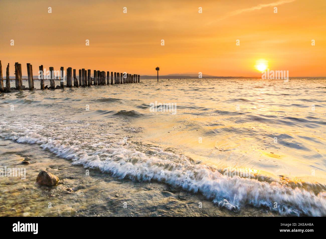 Golden sunrise over the shore of Lake Constance with landing stage near Altnau, Switzerland, Thurgau Stock Photo