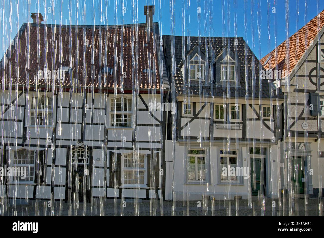 half-timber houses behind the Weberbrunnen fountain on Tuchmacherplatz in the old town of Kettwig, Germany, North Rhine-Westphalia, Ruhr Area, Essen Stock Photo