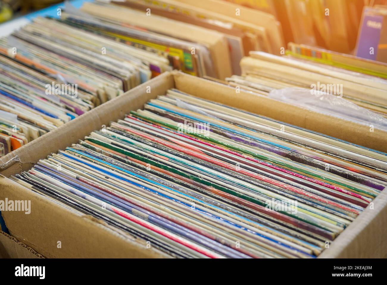 Old vinyl records for record player are in paper box. Antiques. Background. Stock Photo
