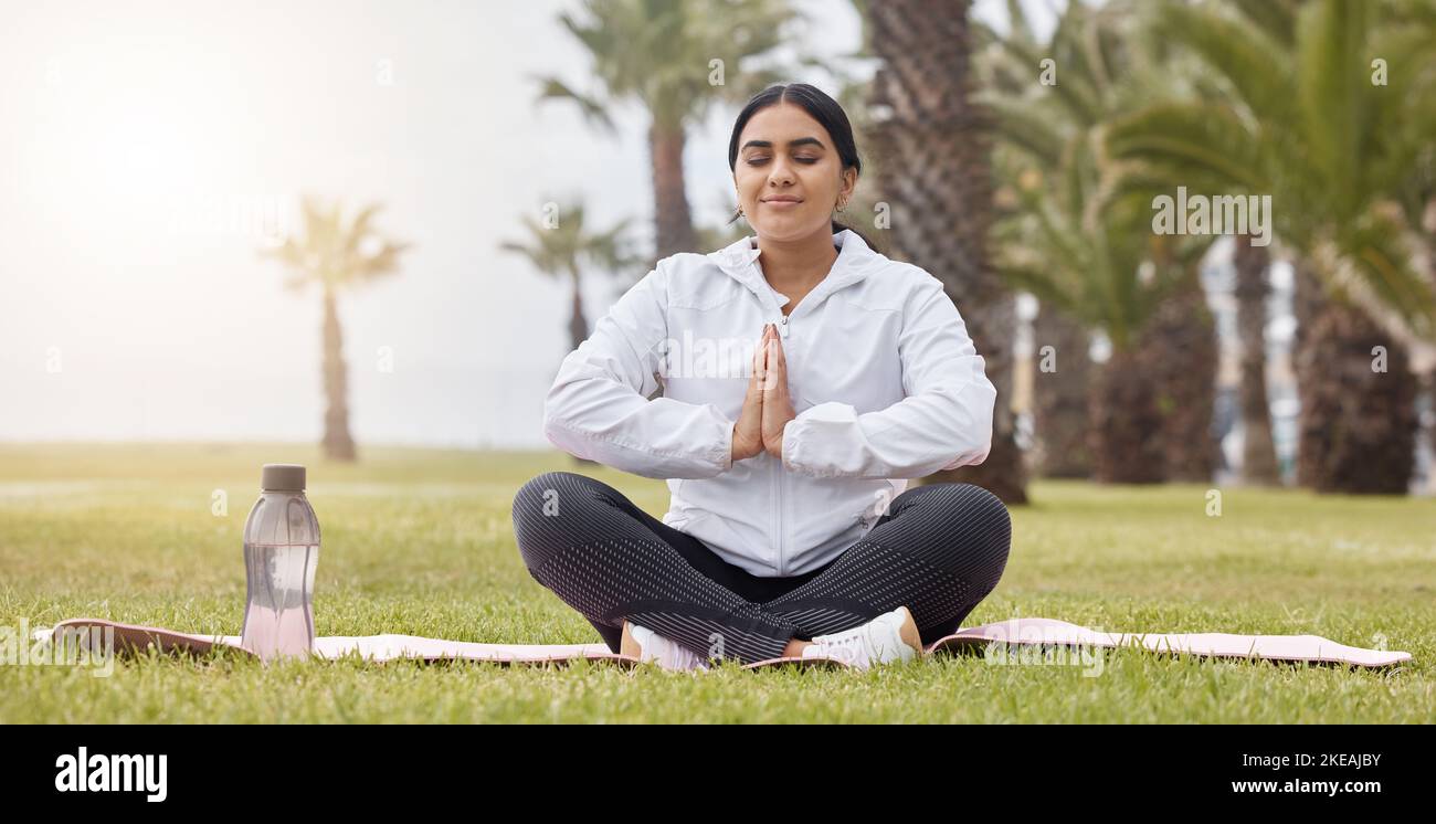 Fitness, meditation and yoga with woman in park for peace, zen and breathing exercise. Relax, energy and freedom with girl training on grass for Stock Photo