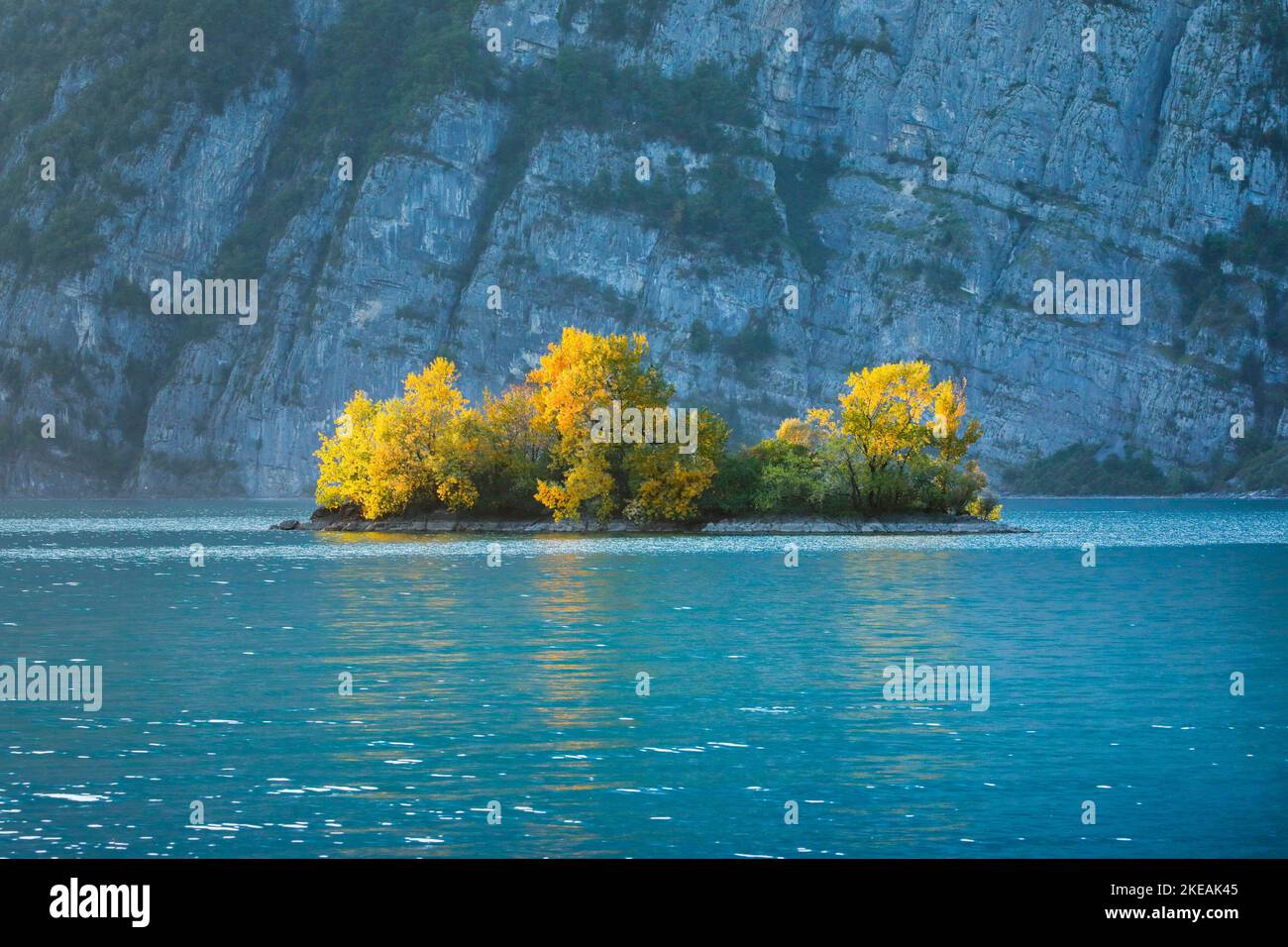 Small island in the turquoise water of Lake Walen, Switzerland, St. Gallen Stock Photo