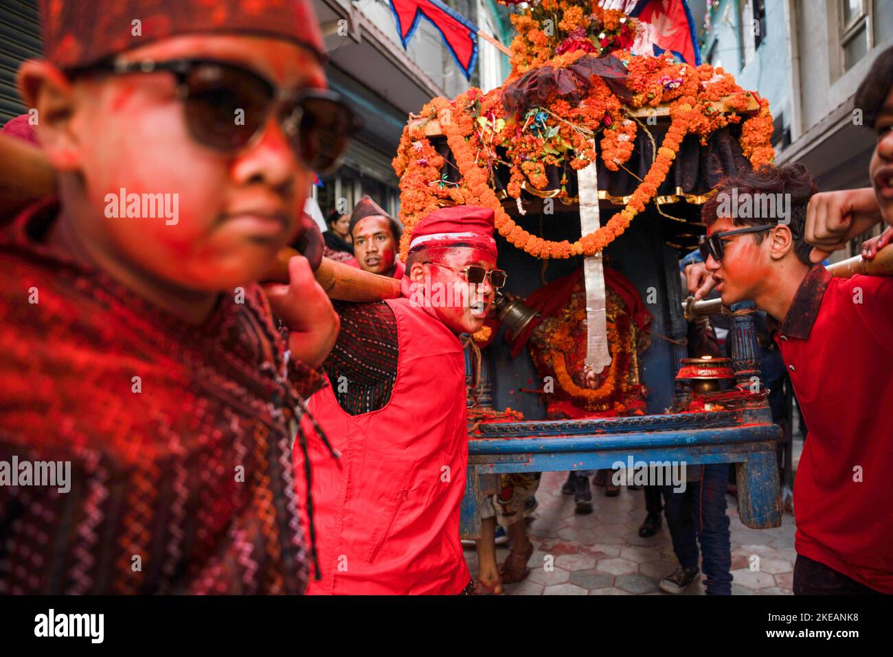 A young boy donned in traditional Newari attire carrying a chariot of ...