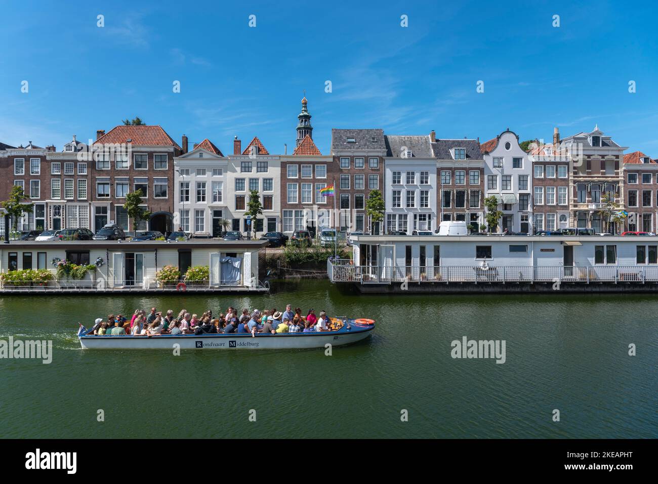 Tour boat in front of historic house facades and houseboats on the Londensekaai, Middelburg, Zeeland, Netherlands, Europe Stock Photo