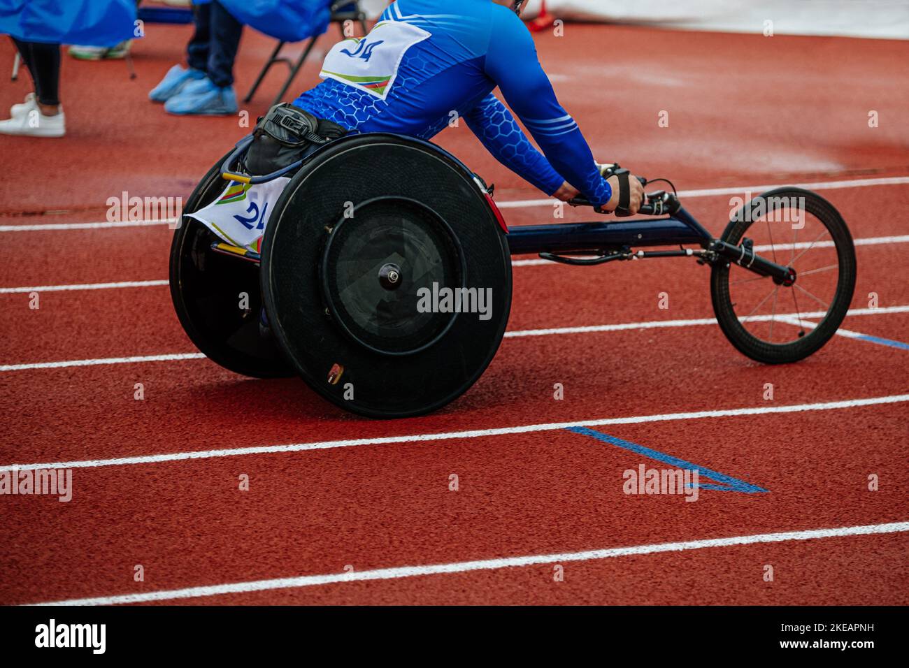 male athlete in wheelchair racing competition at stadium Stock Photo