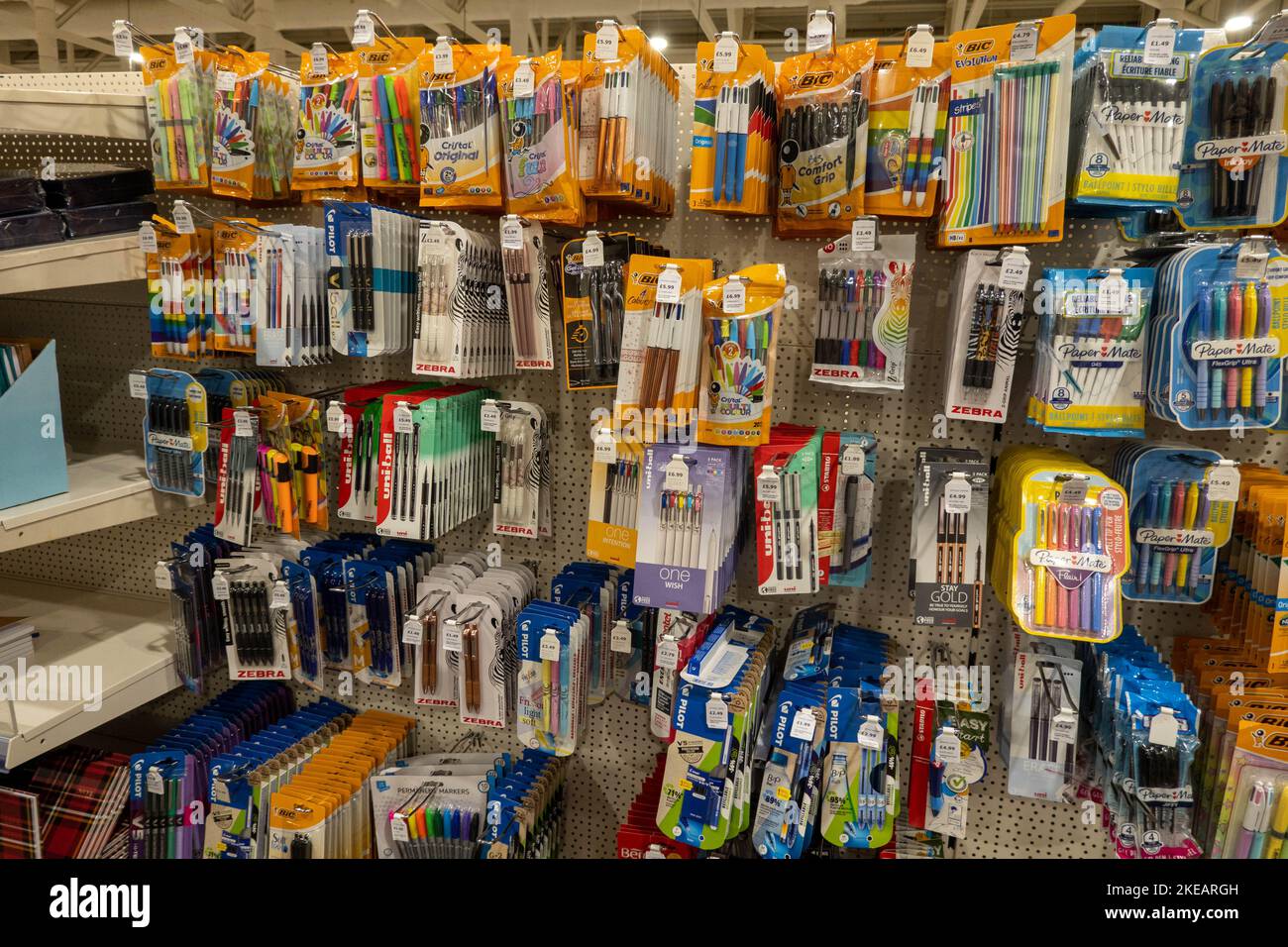 Various stationary items I.e. pens,pencils tape on hooks and shelves at