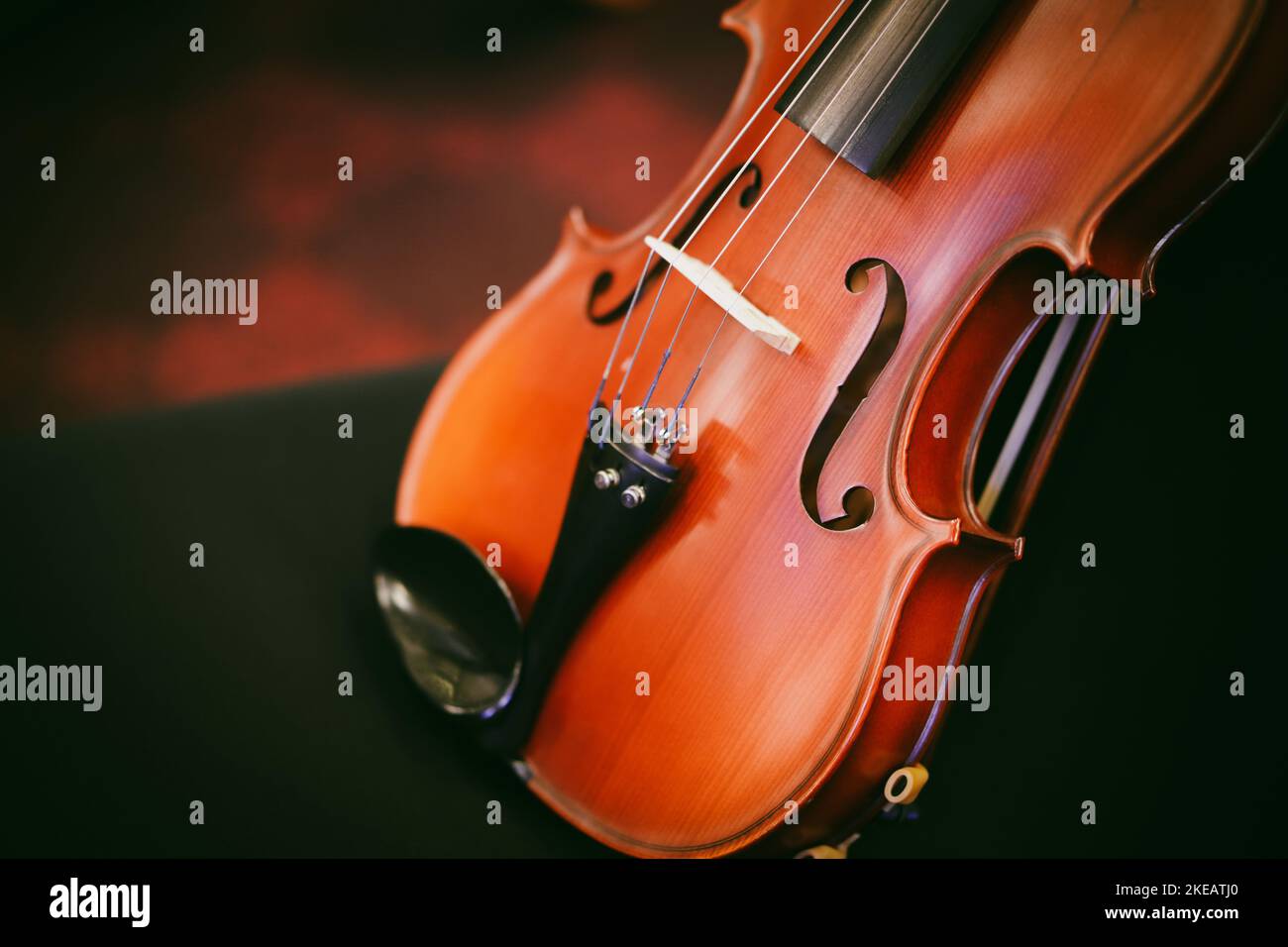 Detail view of a violin on a black chair. Stock Photo