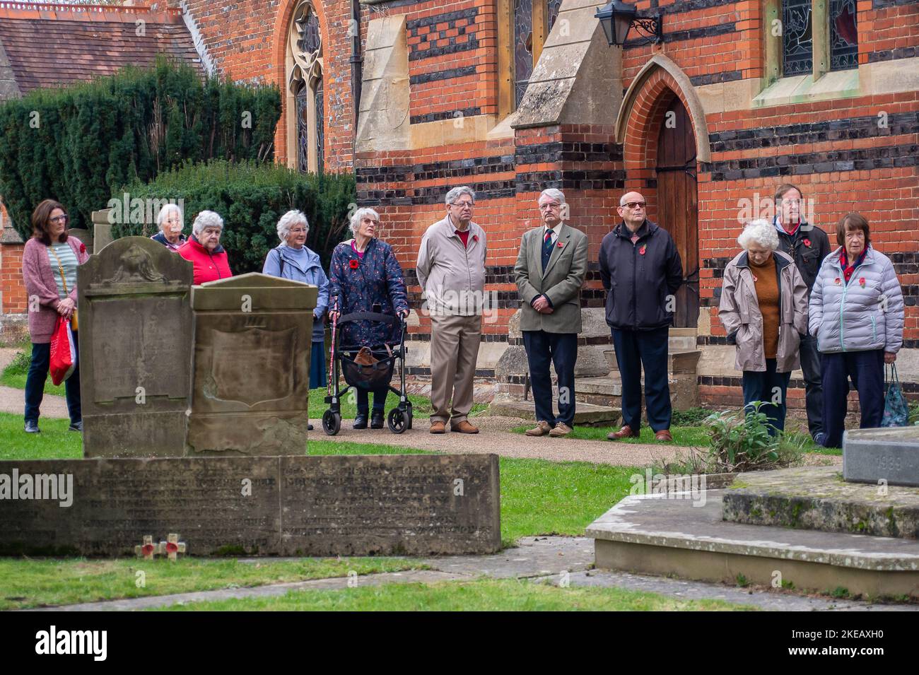 Chalfont St Peter, Buckinghamshire, UK. 11th November, 2022. Villagers gathered at the parish church in the village of Chalfont St Peter this morning for two minutes silence in memory of our war dead. Prayers were led by Vicar Revd John Goodman. Poppies with the names of villagers who lost their lives in the first and second world wars were placed in the grounds of the church. Credit: Maureen McLean/Alamy Live News Stock Photo