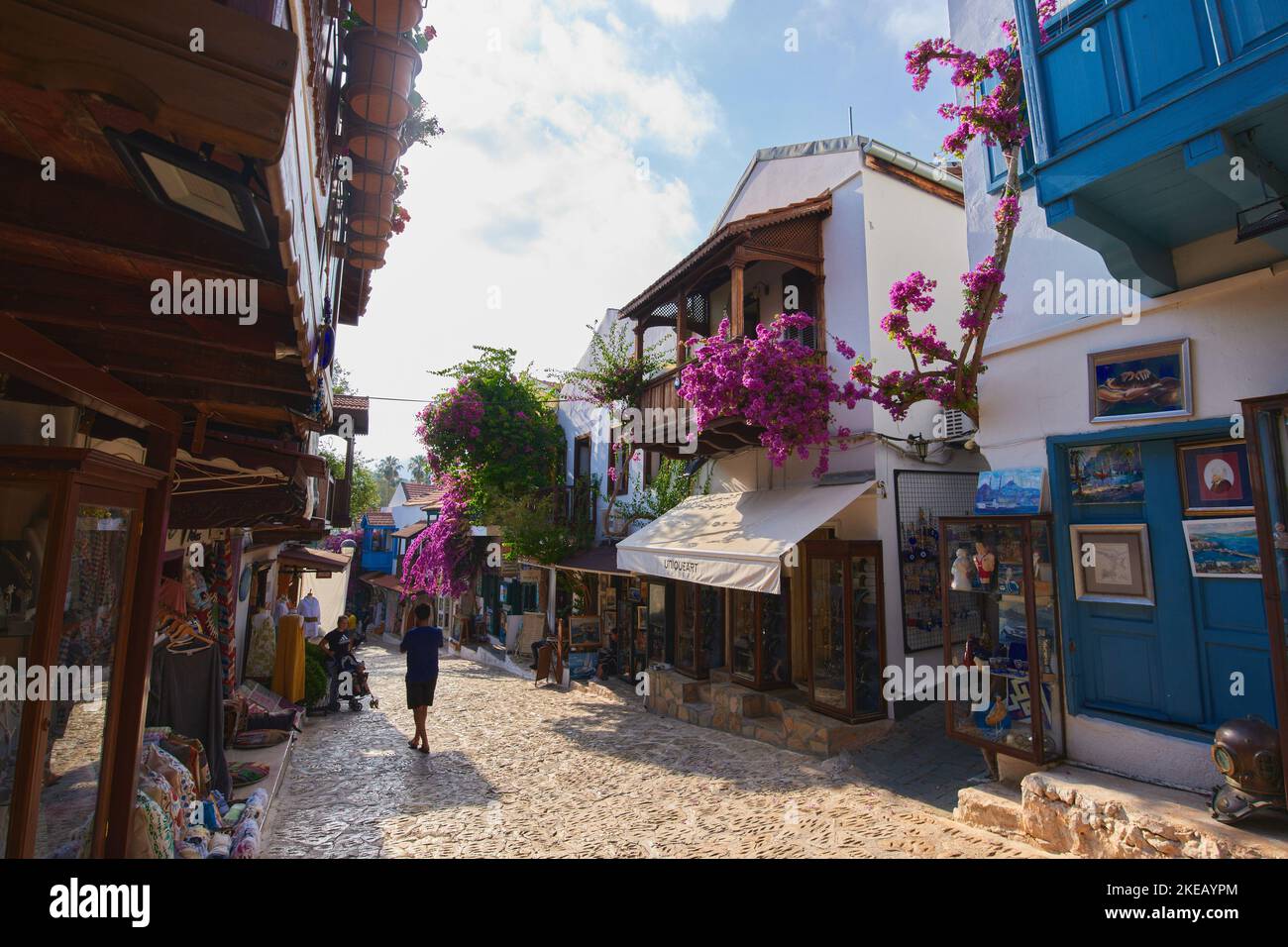 Kas, Turkey - 08 June 2022. Kas town cozy street. Overgrown with flowers Turkish village blooming street. Shop in Kas Stock Photo