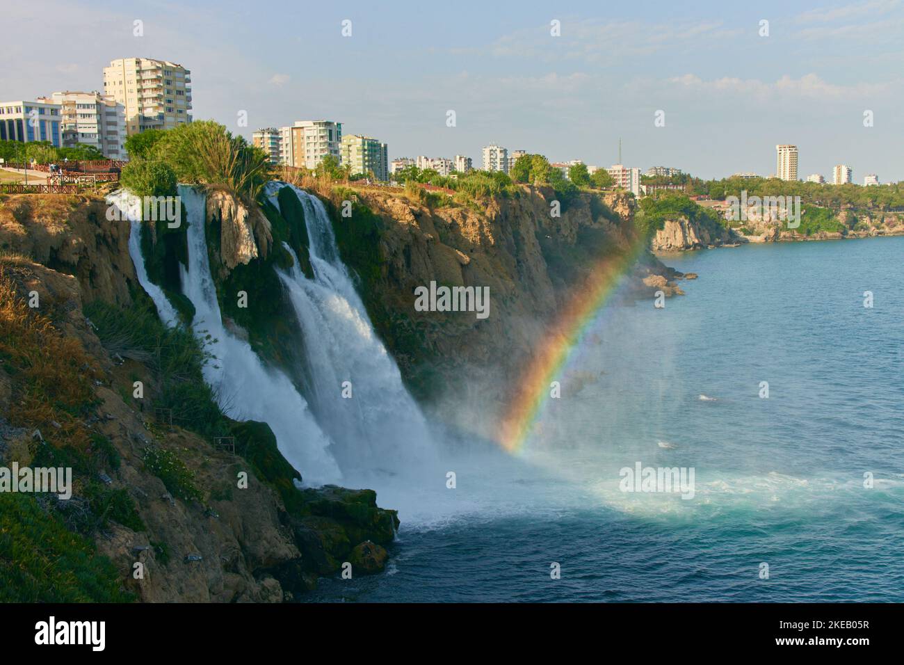 Lower Duden Waterfall in Antalya, Turkey. A beautiful landscape of waterfall, rainbow, sea and city Stock Photo