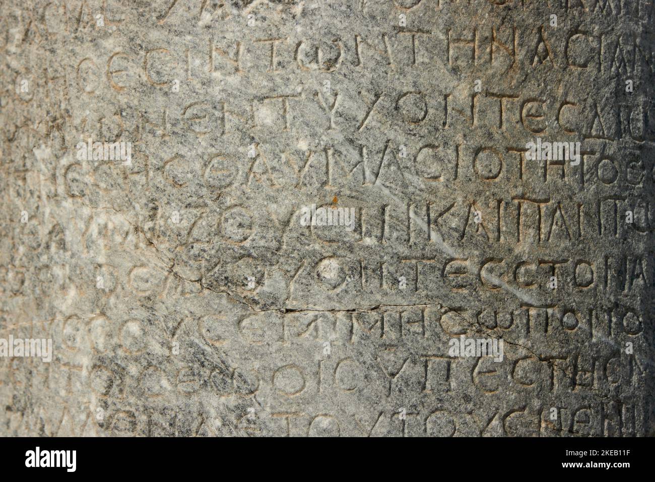 The ancient inscription is on the antique column or the wall. Ancient