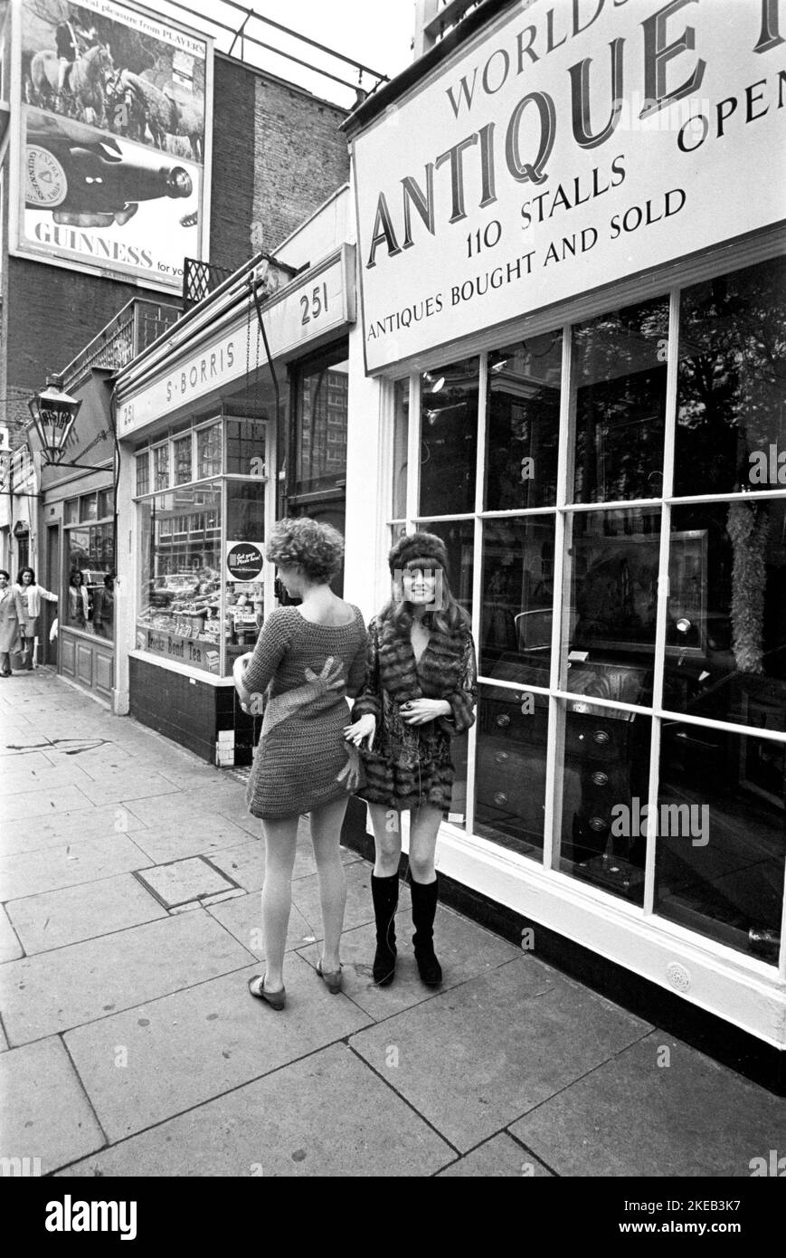 London in the 1960s. Birgitta Bjerke and Ulla Larsson at 251 Kings Road in front of the Antique market stalls. They are wearing the very typical 1960s fashion of their own design. Picture taken during the era of the Swinging Sixties, a youth-driven cultural revoluton in the UK in the mid to late 1960s. Note the typical hand patterned clothing.  London England October 1967. Stock Photo