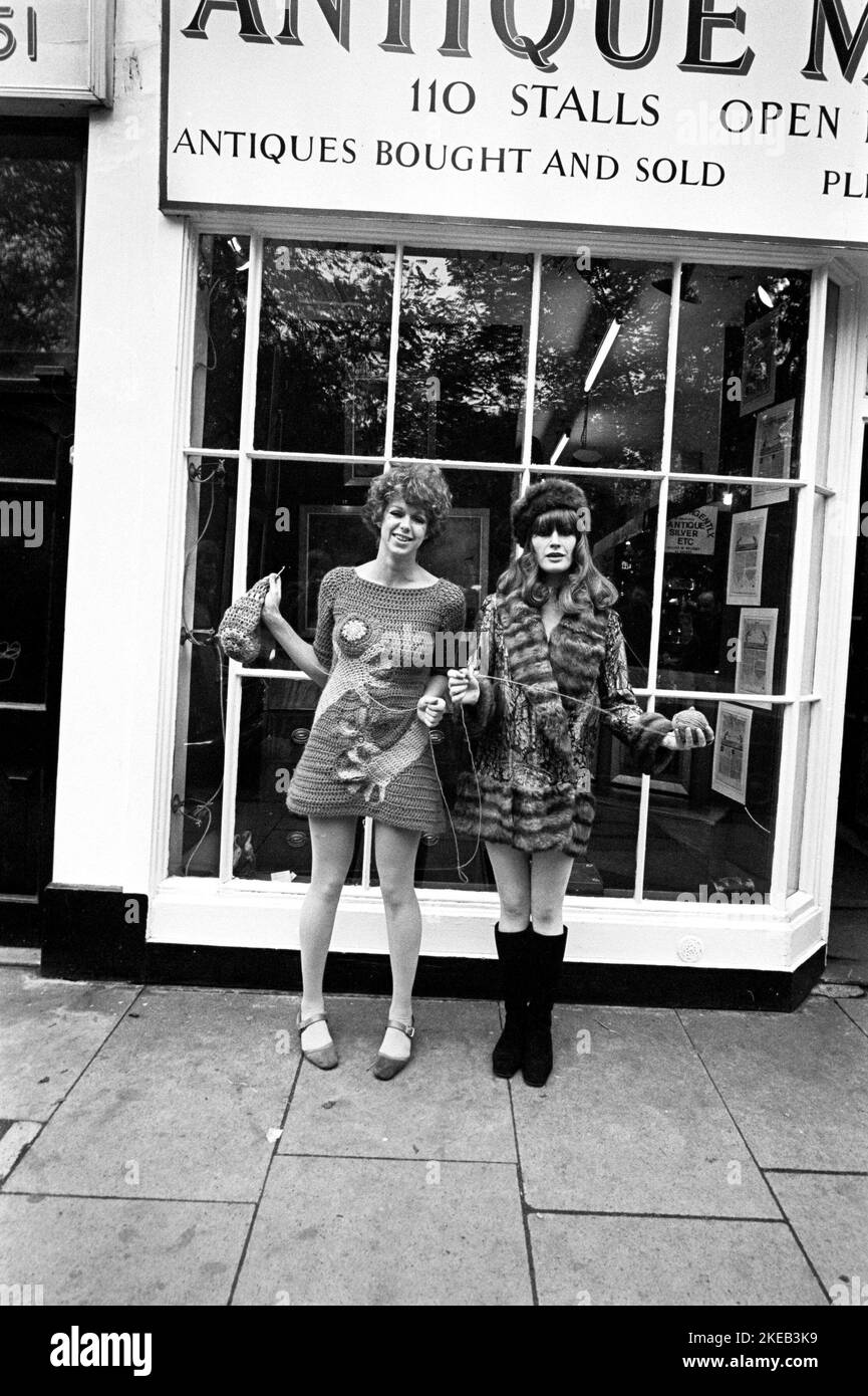 London in the 1960s. Birgitta Bjerke and Ulla Larsson at 251 Kings Road in front of the Antique market stalls. They are wearing the very typical 1960s fashion of their own design. Picture taken during the era of the Swinging Sixties, a youth-driven cultural revoluton in the UK in the mid to late 1960s.  London England October 1967. Stock Photo