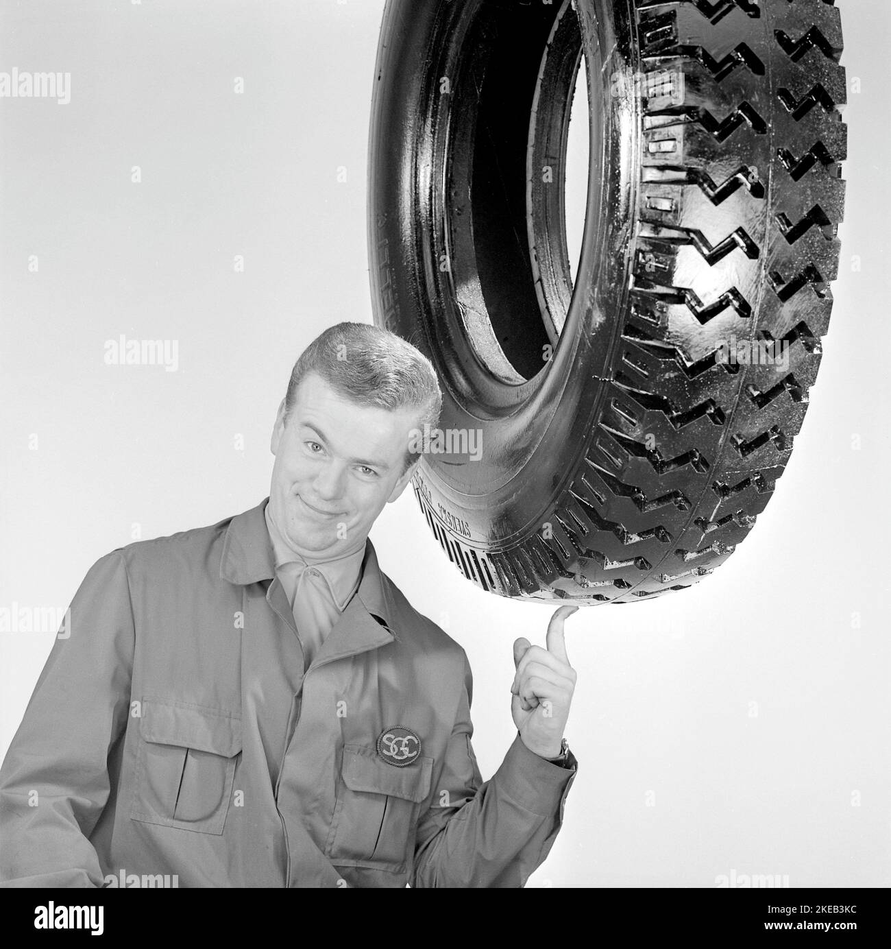 In the 1960s. A man with a large car tire in a picture arranged to make