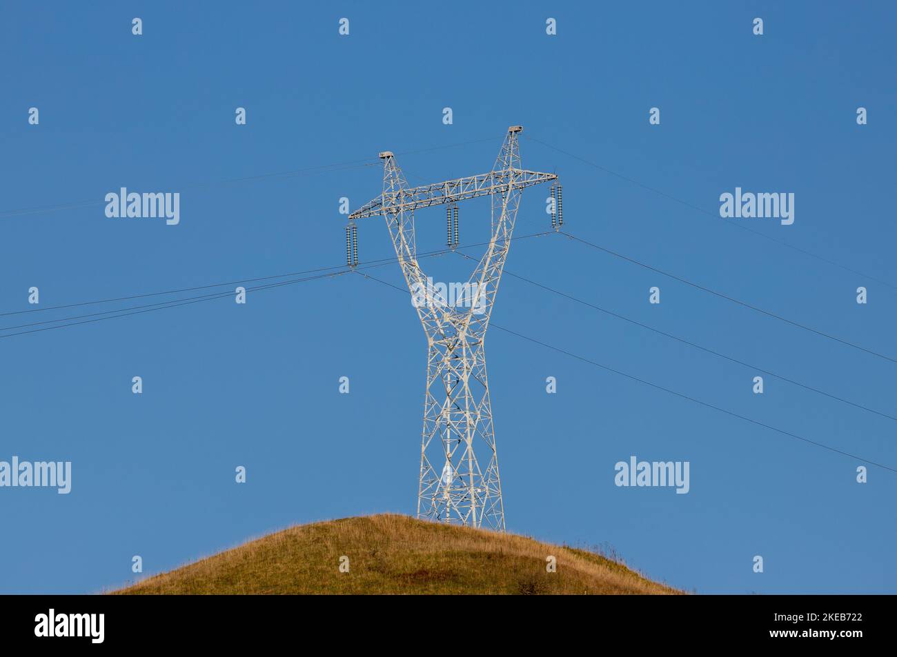 a high voltage metal pole on a blue sky background Stock Photo - Alamy