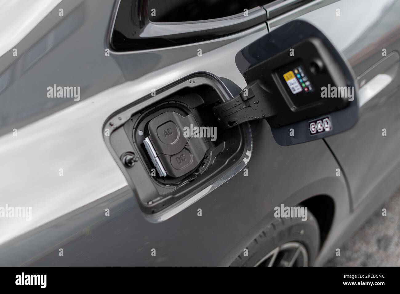 Close up of electric vehicle AC and DC charge port options on modern grey vehicle Stock Photo