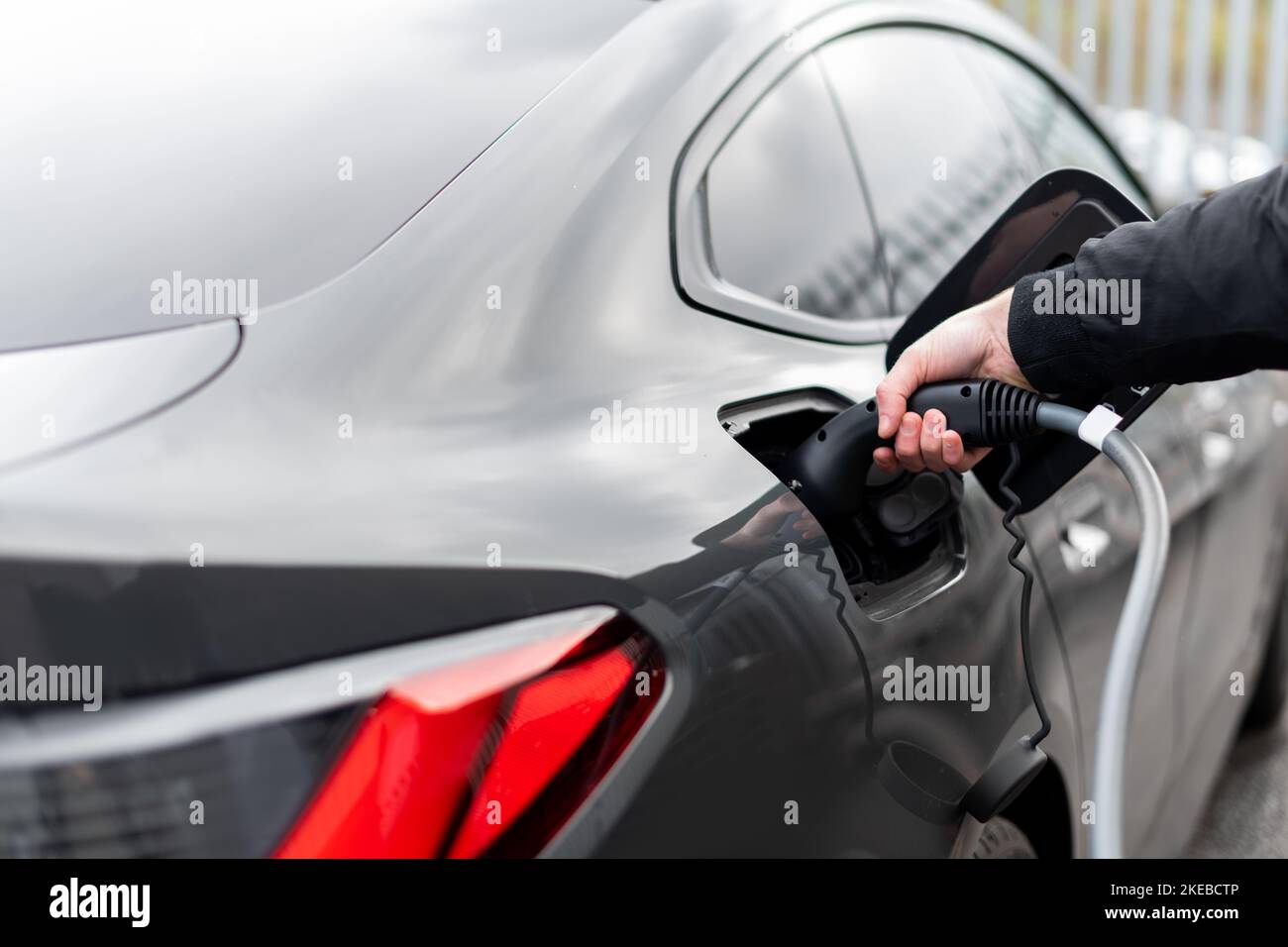 Close up of electric vehicle plug in charge stop Modern EV charging
