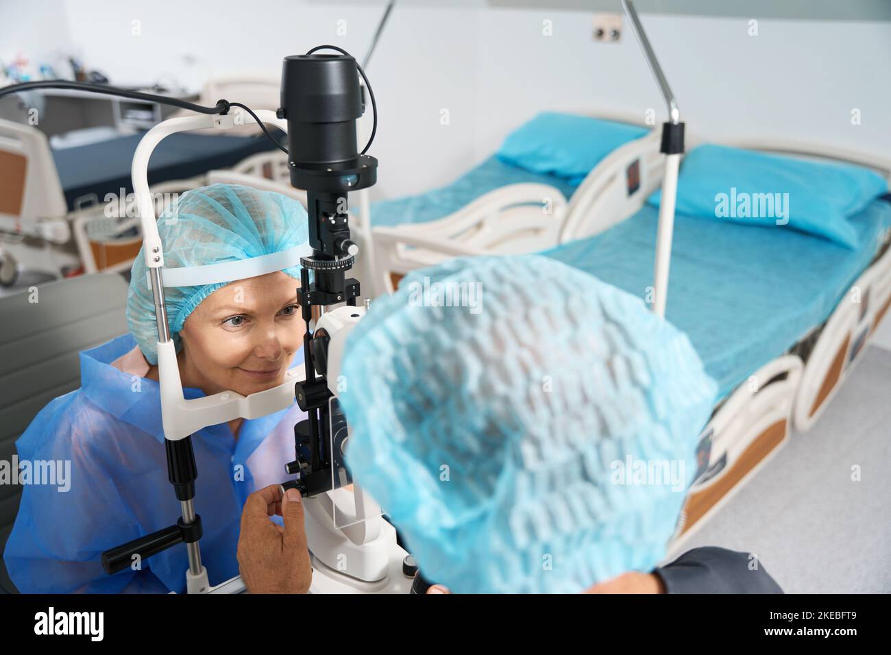 Ophthalmologist examining the eyeball of patient before surgery Stock