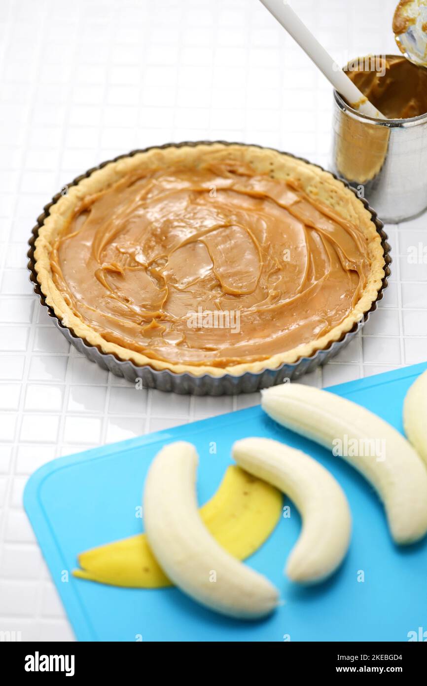 classic banoffee pie recipe; prepare to put bananas on pie crust coated