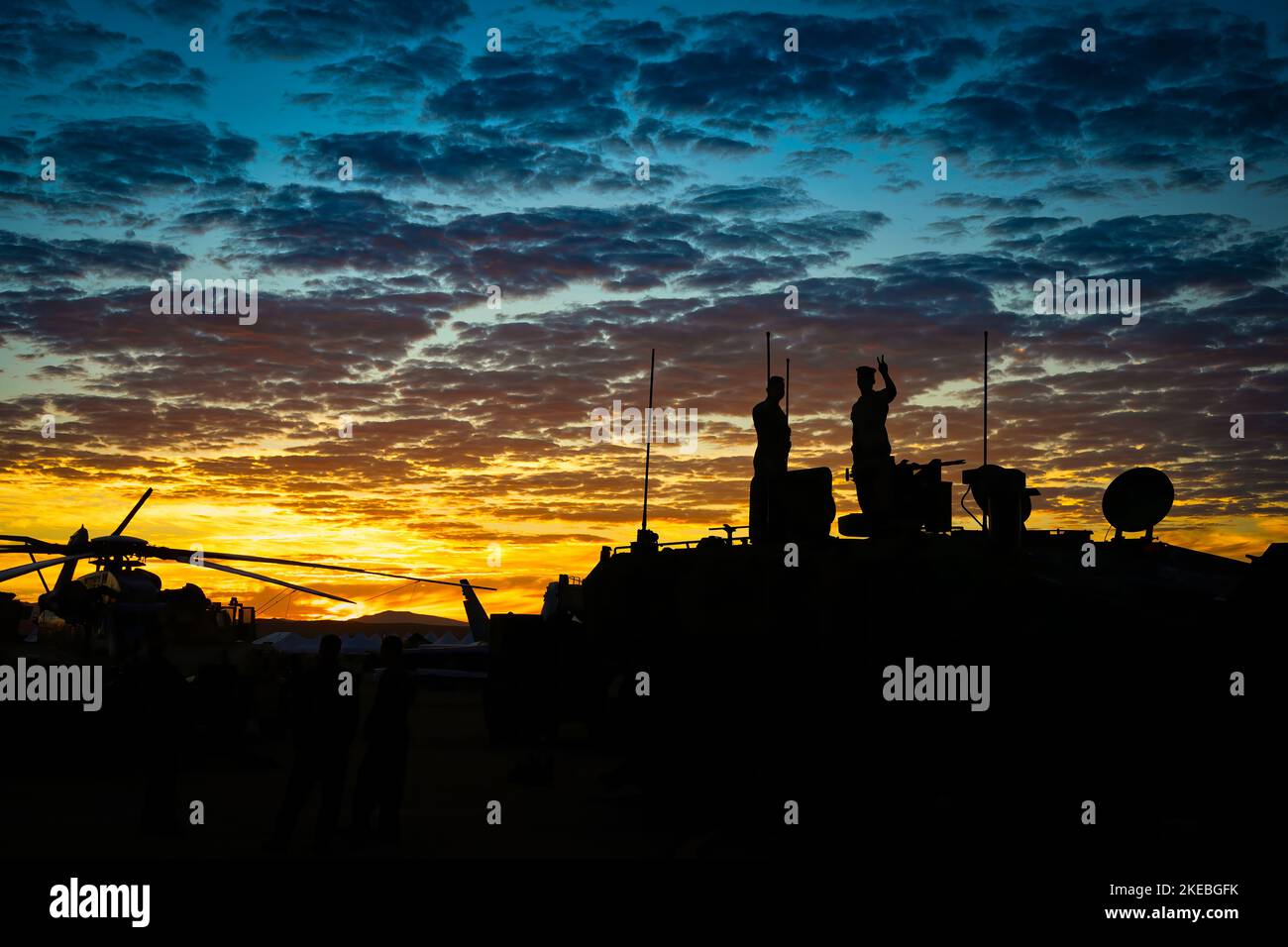 The silhouette of a serviceman standing on a military vehicle and flashing a peace sign, early one morning before the crowds arrive, at the Miramar Ai Stock Photo