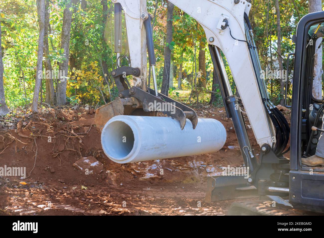 During preparation for underground installation worker uses tractor to