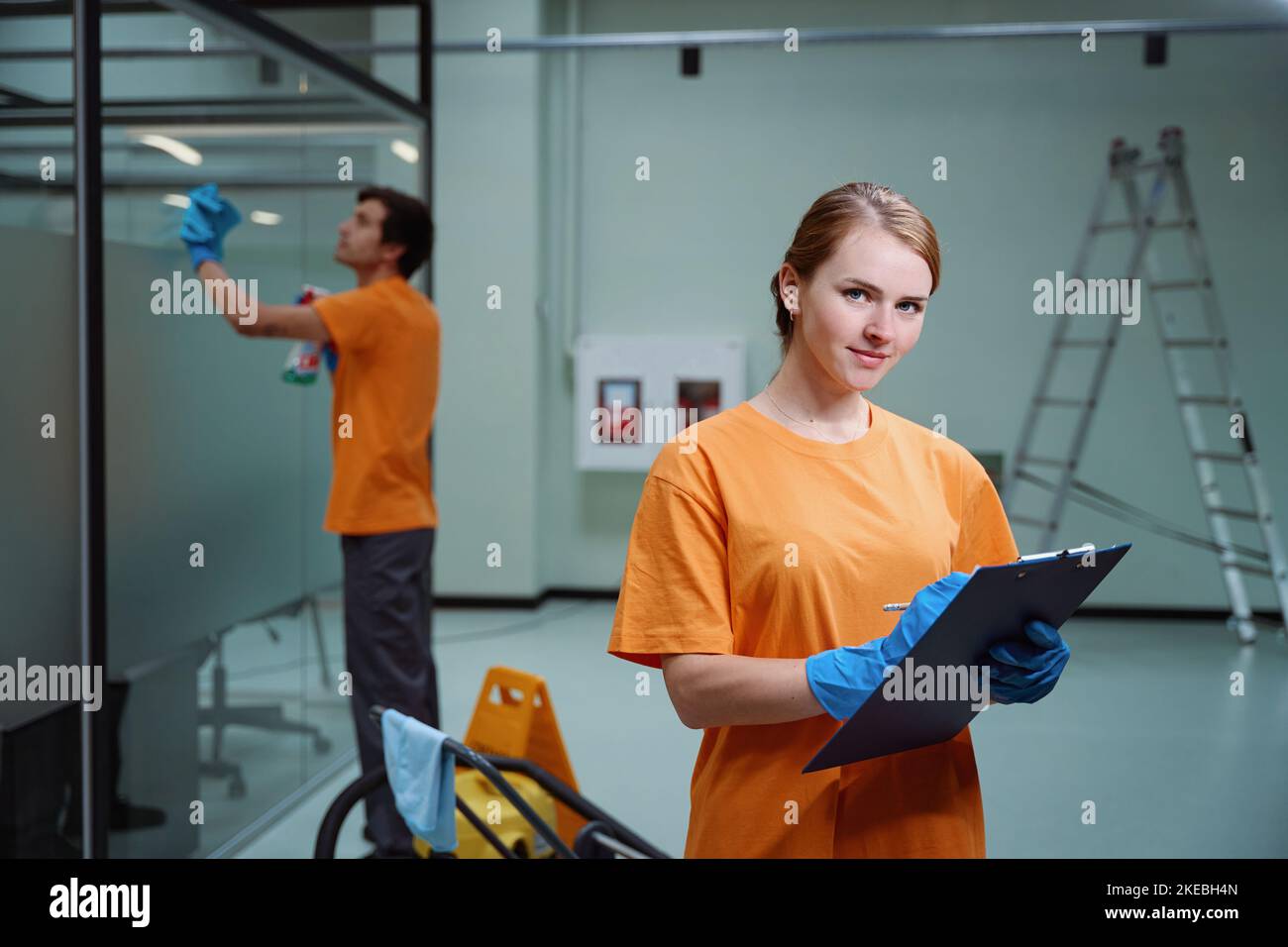 Professional cleaners accomplishing corporate request according to the checklist Stock Photo