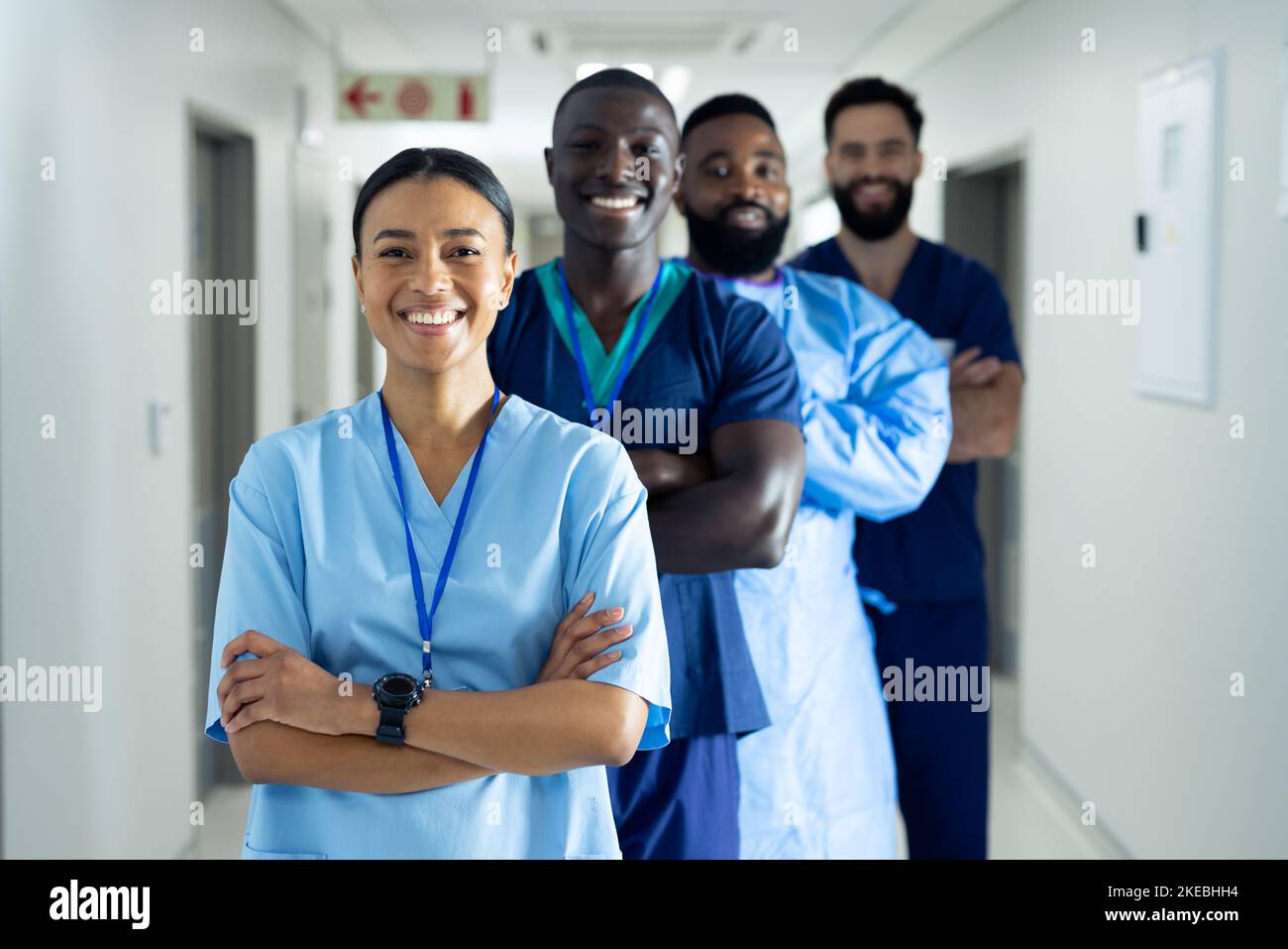 Portrait of diverse group of smiling healthcare workers standing in line in hospital corridor Stock Photo