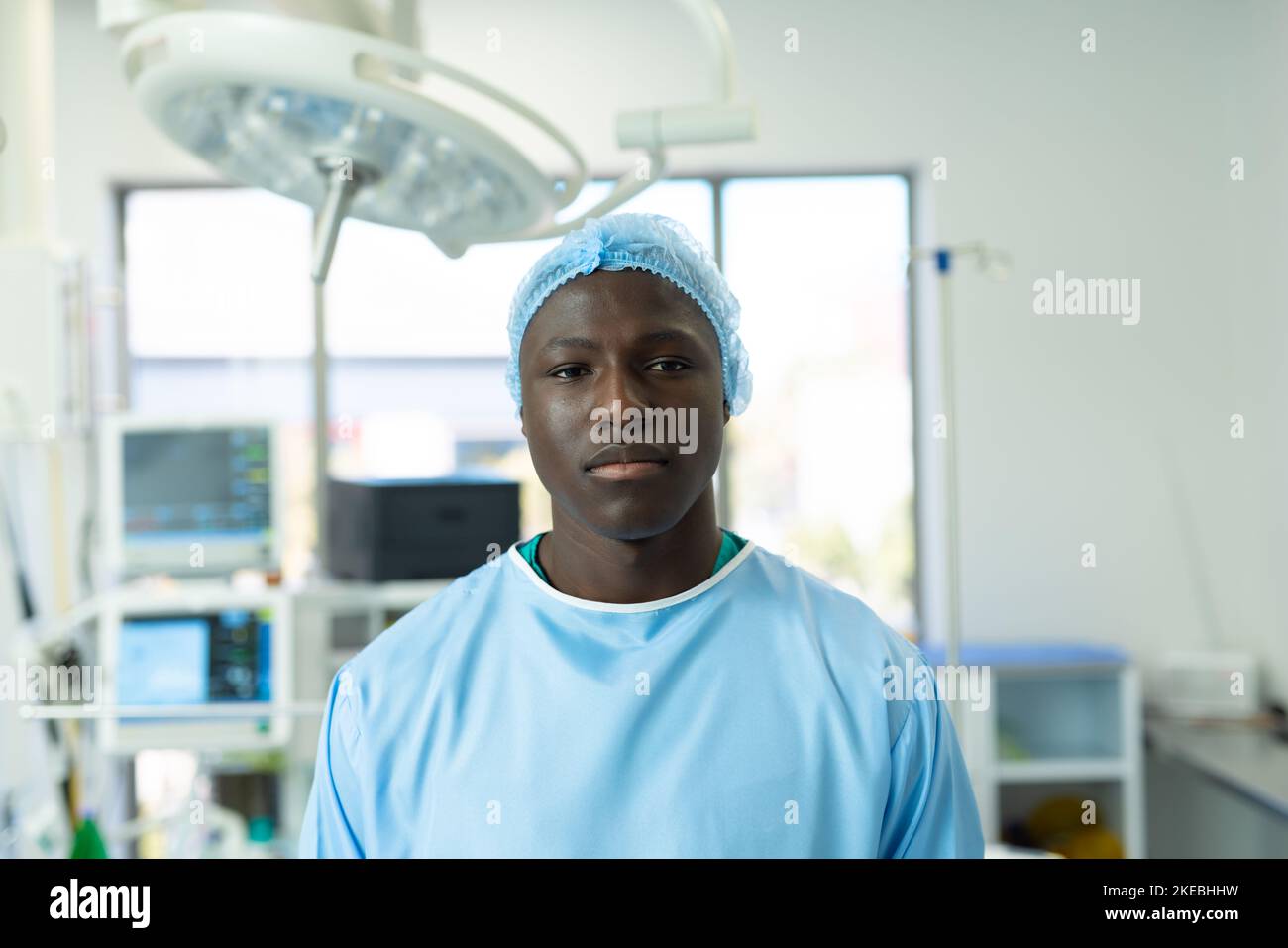 Portrait of african american male healthcare worker in surgical cap and gown in operating theatre Stock Photo