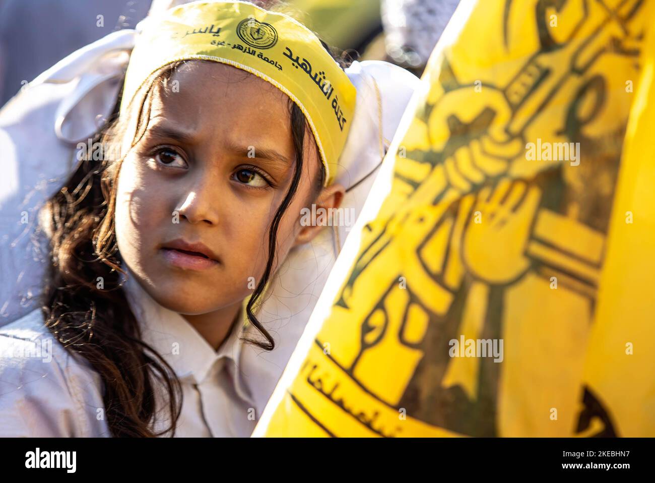 A Palestinian girl wears a blindfold on her head as she looks during a ...