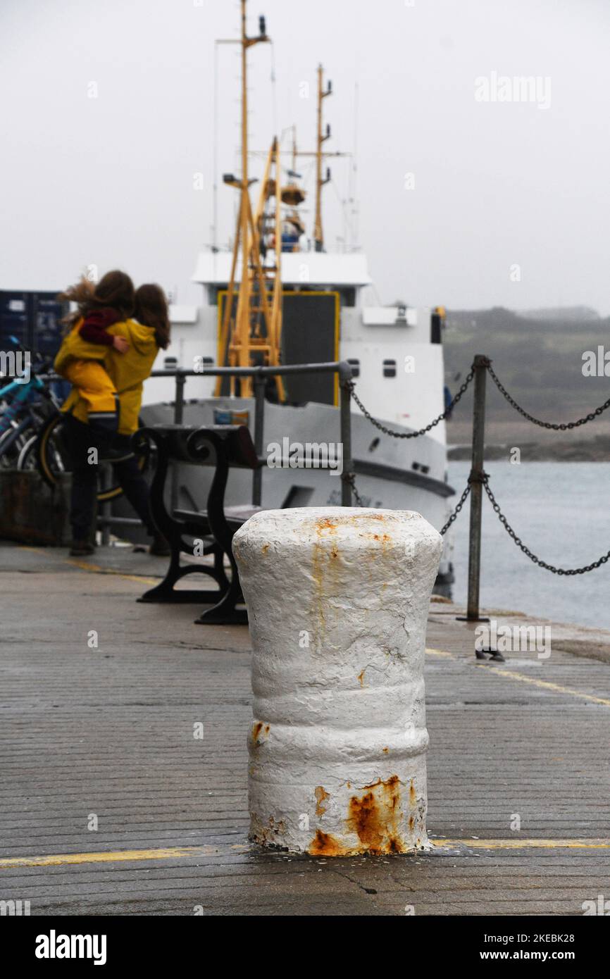 A bollard on the quay in the harbour at Hugh town on the island of St Marys, Isles of Scilly. The bollard is a cannon, set in the quay, from the wreck Stock Photo