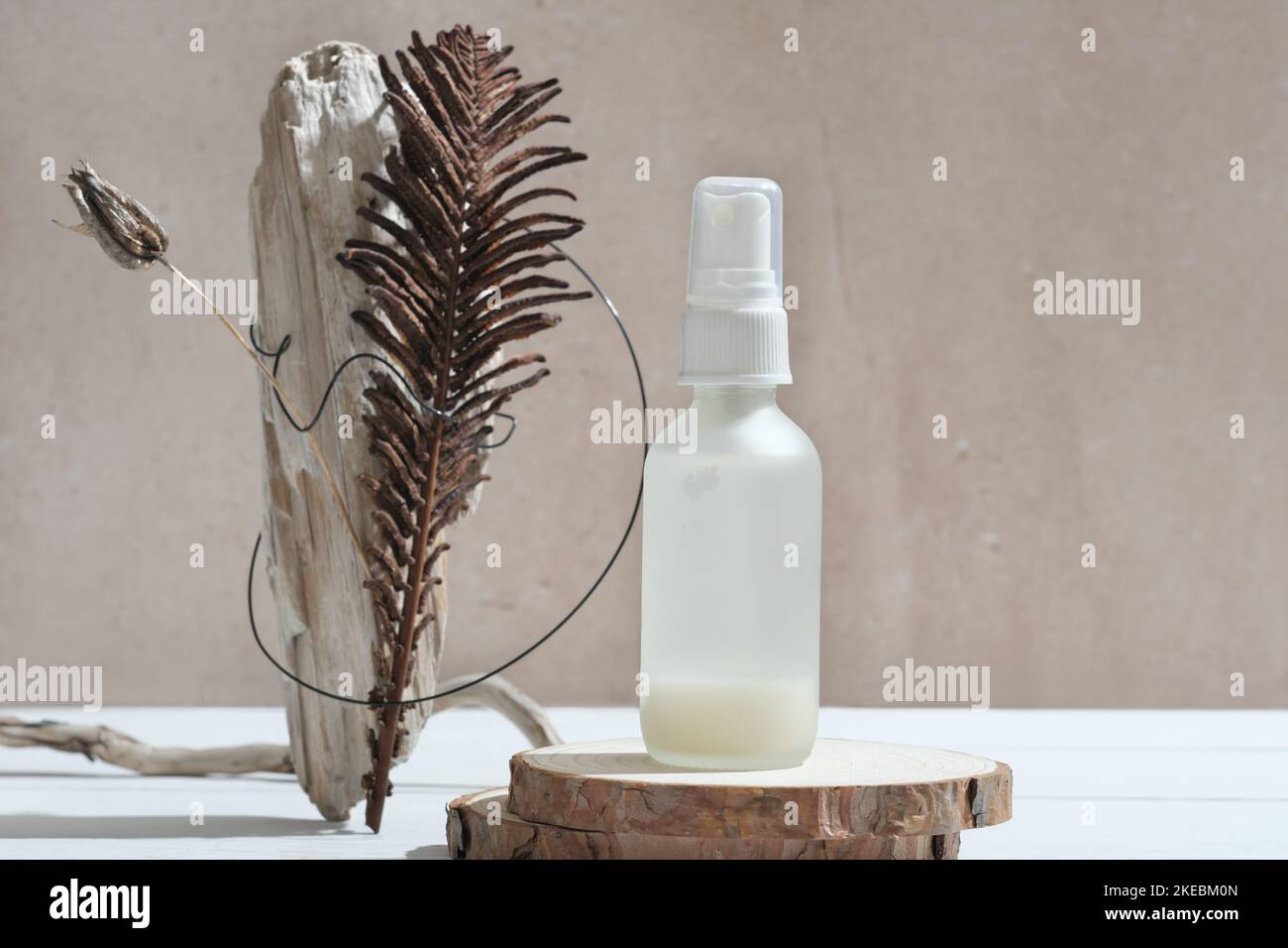 face care serum in white bottle on natural wooden podium next to modern