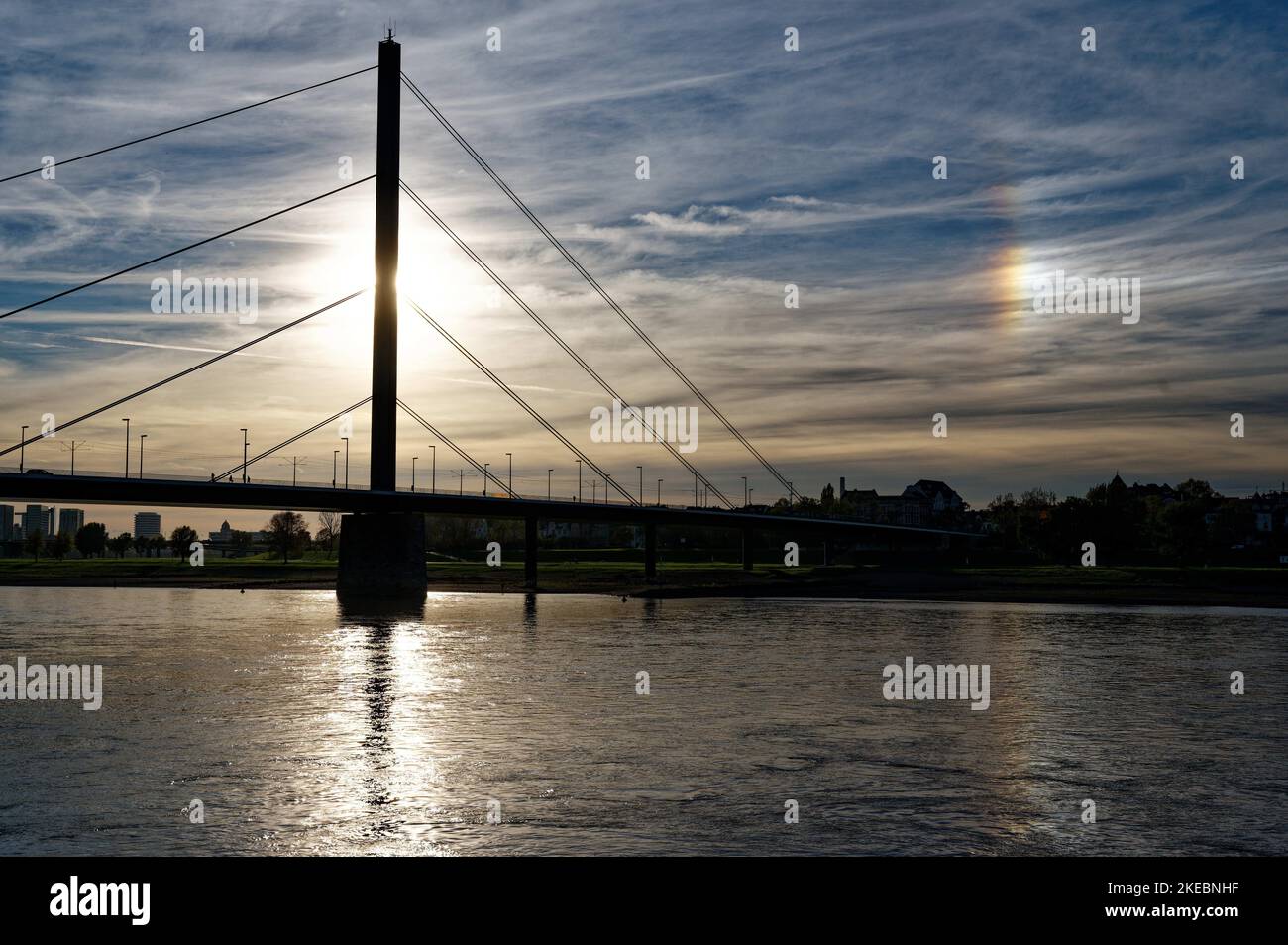 Duesseldorf, Germany. 11th Nov, 2022. A spot of light appear in the afternoon sky at an angle of 22 degrees to the right of the sun. The phenomenon, called a parhelion, is caused by ice crystals in the upper atmosphere. Credit: Henning Kaiser/dpa/Alamy Live News Stock Photo