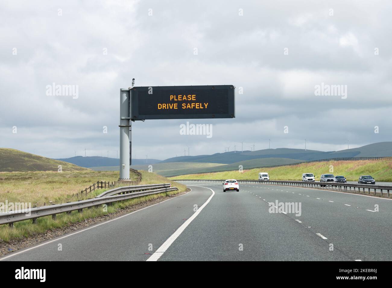 Please Drive Safely motorway overhead variable message sign on M74 motorway, Scotland, UK Stock Photo