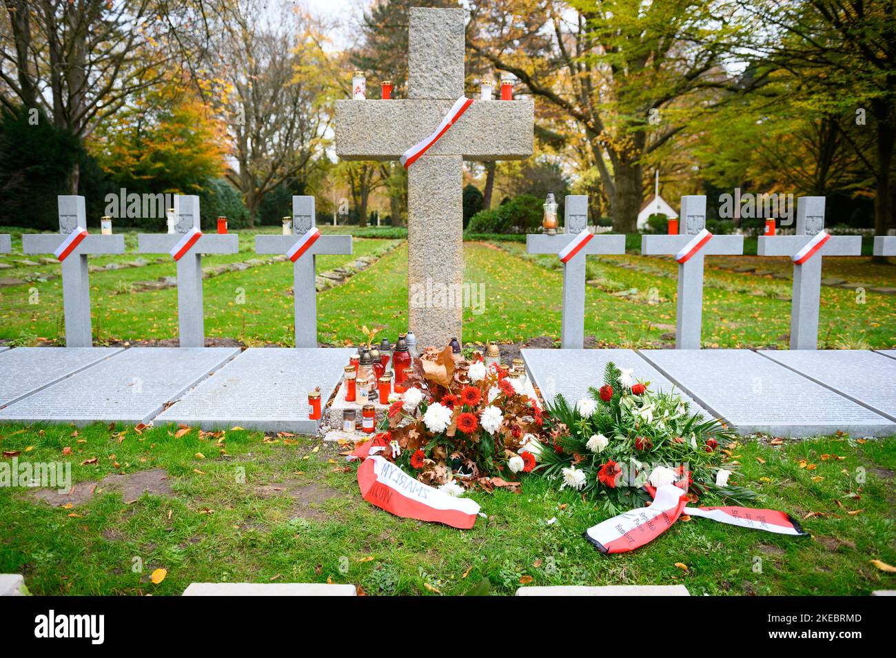 Hamburg, Germany. 11th Nov, 2022. Candles, ribbons and mourning wreaths on crosses in the area of the Polish war gravesite at Ohlsdorf Cemetery. When caring for Soviet war graves in Hamburg, the German War Graves Commission wants to make a greater distinction between Russian and Ukrainian dead in the future. Credit: Jonas Walzberg/dpa/Alamy Live News Stock Photo