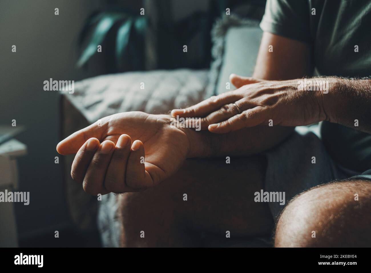 Articulation and writs pain health problems concept with man holding his wrist. Close up of bad body condition concept at home. After exercise prblems on arm and hands. Arthrosis and age Stock Photo