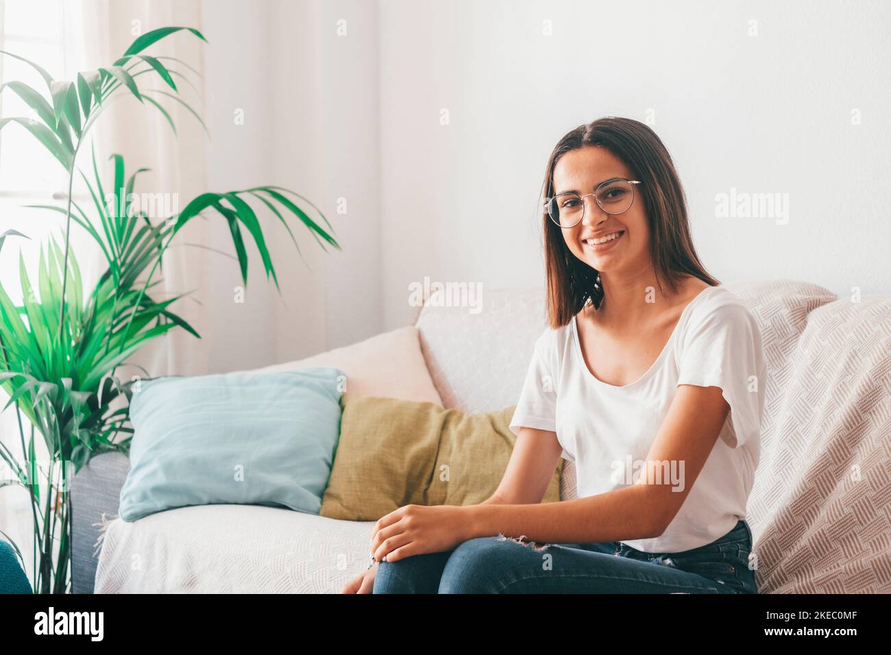 Beautiful woman relaxing on living room sofa hi-res stock photography ...