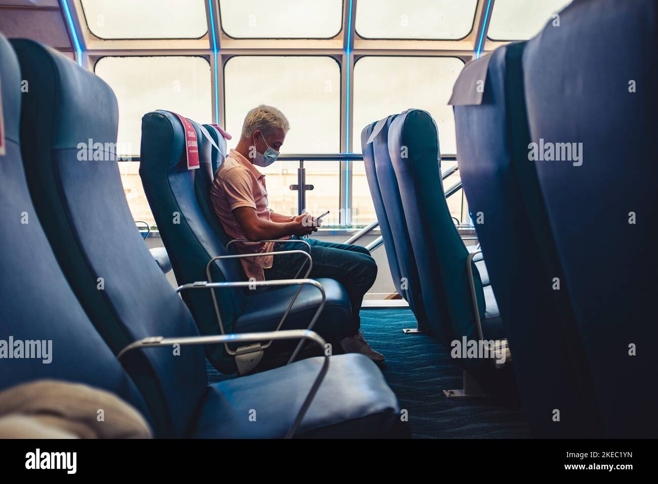one young man using his phone or device on the travel with ship or boat