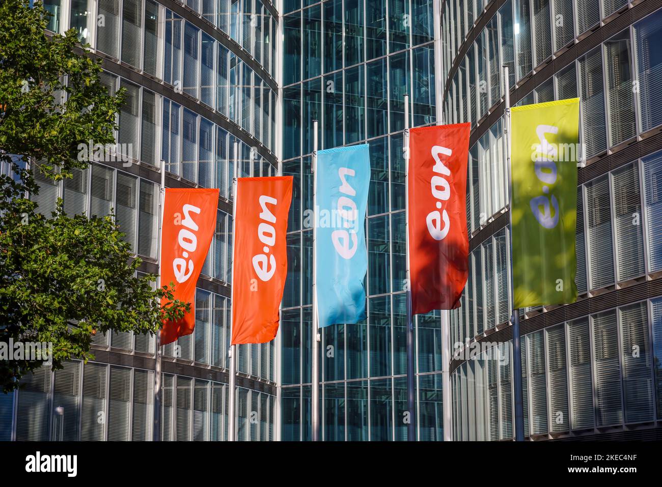 Essen, North Rhine-Westphalia, Germany - E.ON headquarters. e.on company logos on flags in front of the headquarters. Stock Photo
