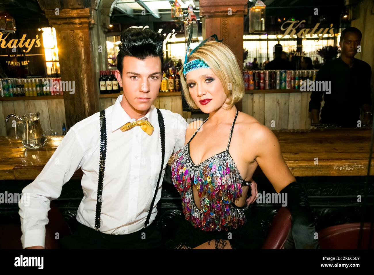 A young couple in Burlesque themed costumes at a fancy party event in