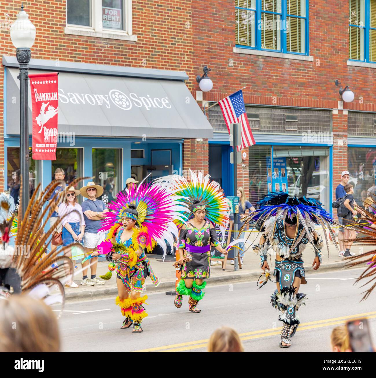 People in colorful feathered costumes in the franklin rodeo parade Stock Photo