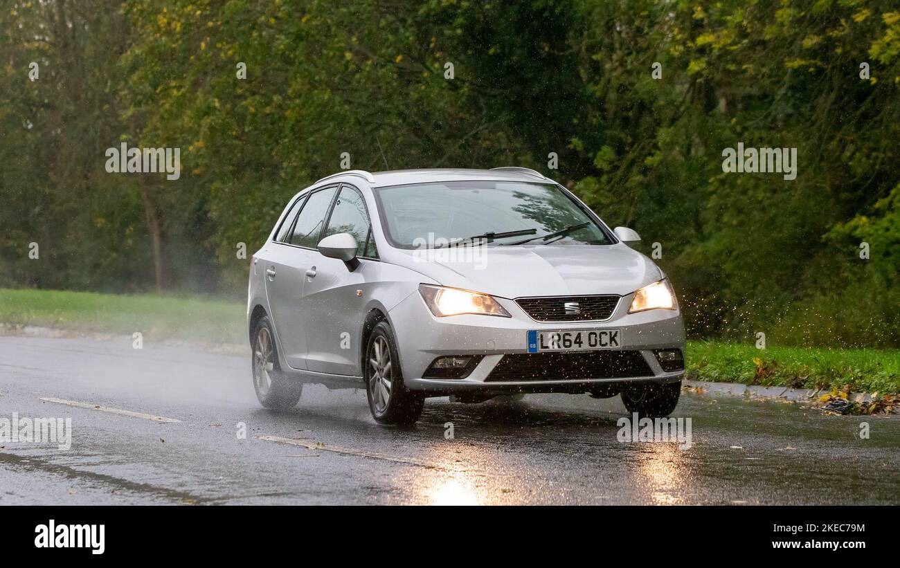 2014 Seat Ibiza driving in the rain on a wet road Stock Photo
