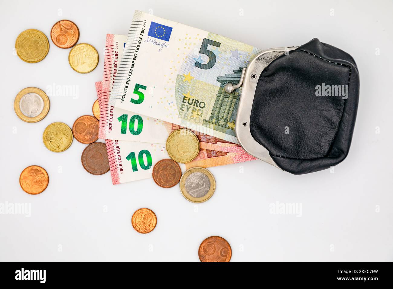 Small change in euro coins and banknotes and a small purse as a sign of poverty Stock Photo