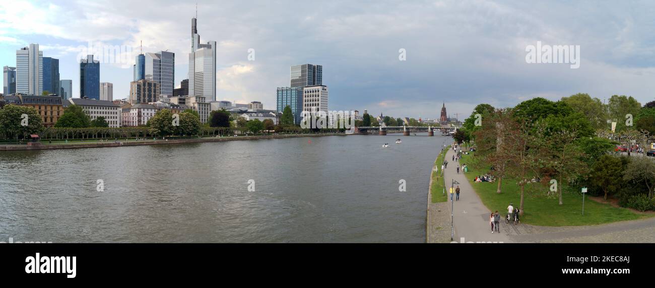 View upstream of river Main, with skyline of modern skyscrapers of the right bank, panoramic shot, Frankfurt, Germany Stock Photo