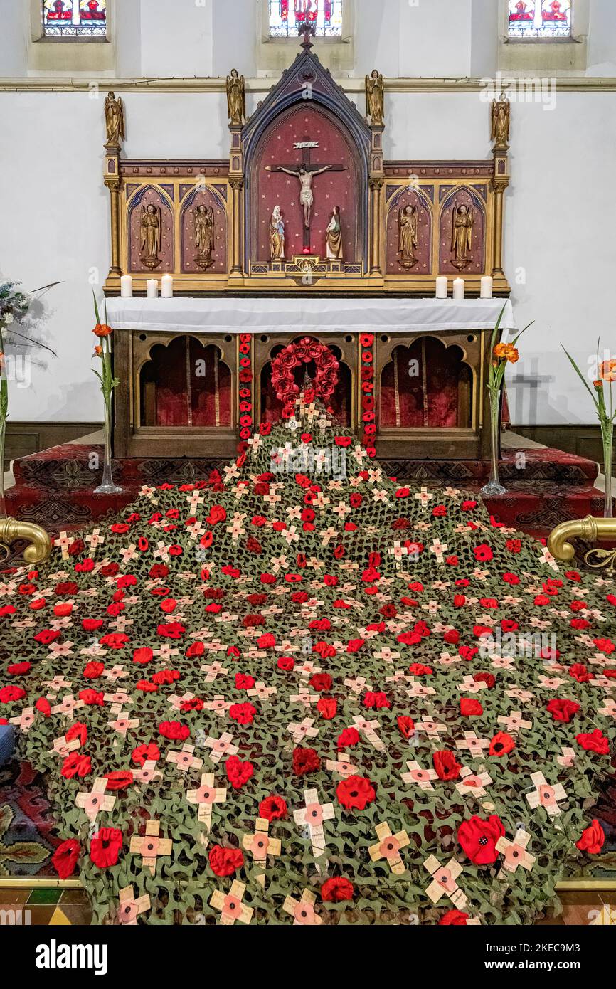 11 November 2022, Armistice Day. An impressive display of knitted poppies and poppy crosses to commemorate the servicemen and women killed during both world wars and subsequent conflicts, in St Mark's Church, Farnborough, Hampshire, England, UK. Stock Photo