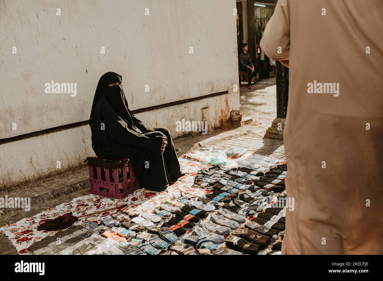 Saudi Arabia, Mecca province, city: Jeddah/Jiddah, woman, veiled, street sale, socks Stock Photo